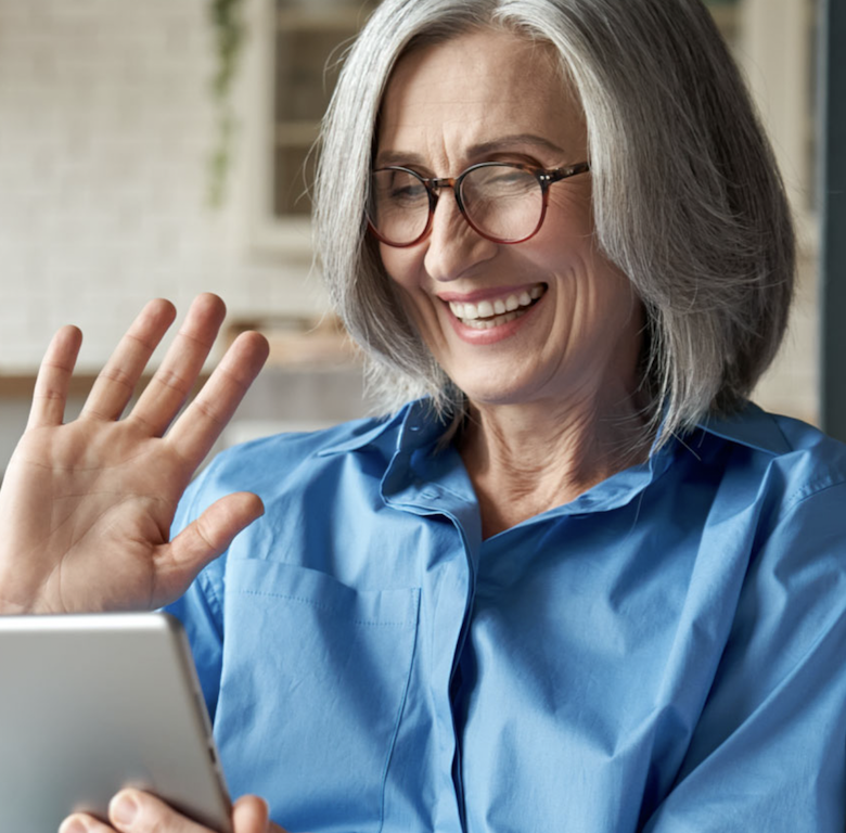 patient waving at mobile device