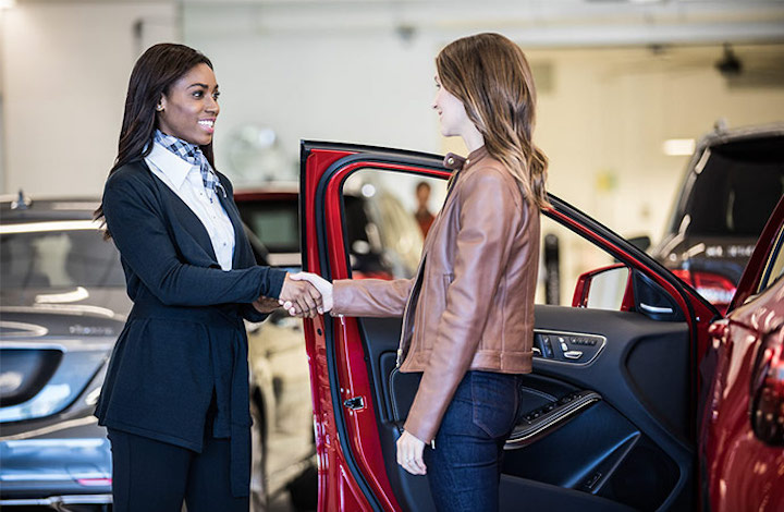 car dealership handing over keys