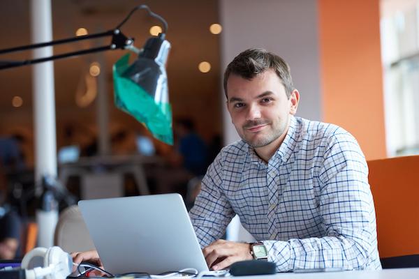 Man sitting at desk with laptop 