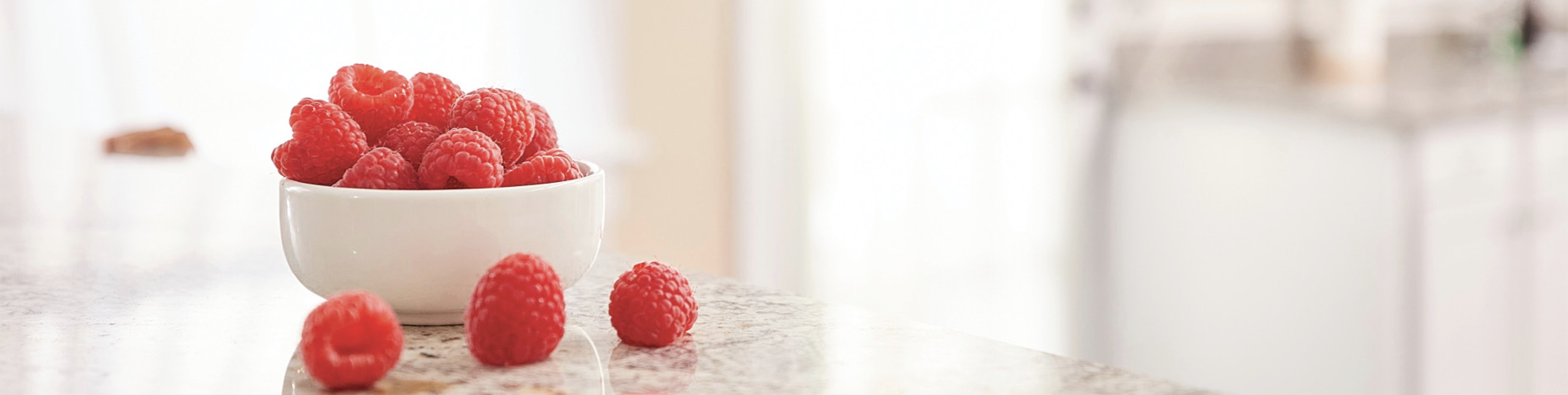 raspberries in bowl on table