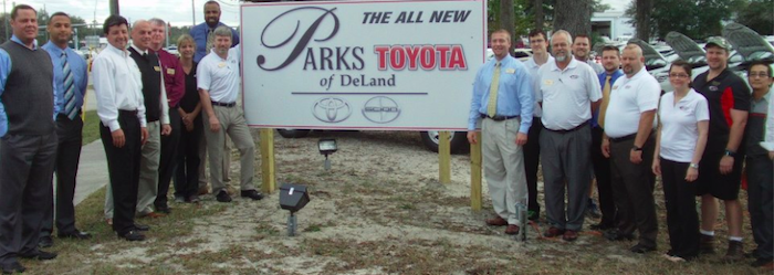 Parks Toyota team in front of brand new construction sign