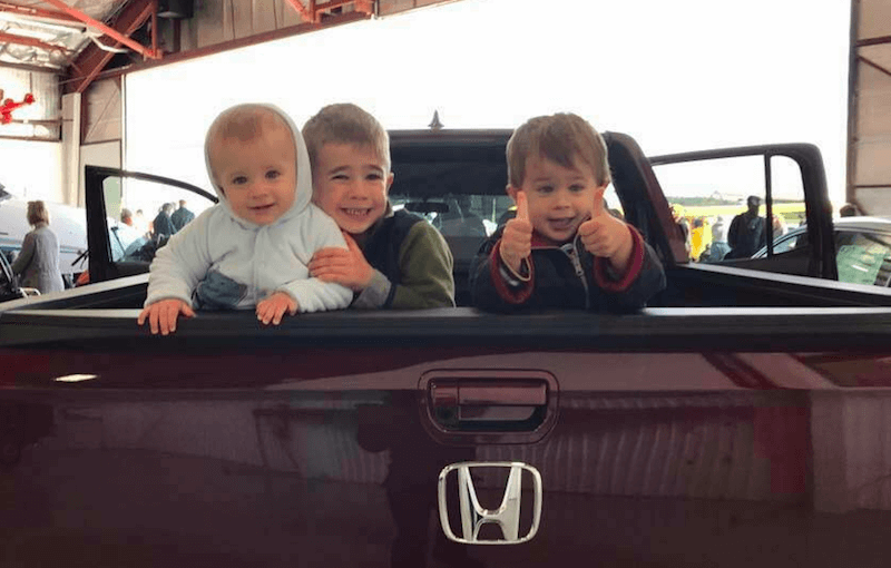 Shockley Honda dealership and children in the back of a truck